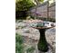 Bird bath and landscaping in backyard at 5202 Woodside Dr, Indianapolis, IN 46228
