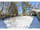 Spacious backyard with snow covered lawn and wooden fence at 5202 Woodside Dr, Indianapolis, IN 46228