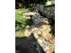 Landscaped backyard with a dry creek bed feature at 5202 Woodside Dr, Indianapolis, IN 46228