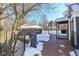 View of backyard deck and fenced yard with snow at 5202 Woodside Dr, Indianapolis, IN 46228
