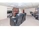 Finished basement with a fireplace, seating, and workspace at 5202 Woodside Dr, Indianapolis, IN 46228