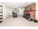Finished basement with a fireplace, seating, and built-in shelving at 5202 Woodside Dr, Indianapolis, IN 46228