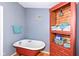 Bathroom with clawfoot tub and wooden storage cabinet at 5202 Woodside Dr, Indianapolis, IN 46228