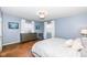 Serene bedroom with hardwood floors, light blue walls, and a king-size bed at 5202 Woodside Dr, Indianapolis, IN 46228
