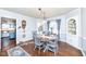 Dining room with hardwood floors, built-in hutch, and a wooden table at 5202 Woodside Dr, Indianapolis, IN 46228