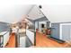 Open loft area with hardwood floors, and a view of the Primary bedroom at 5202 Woodside Dr, Indianapolis, IN 46228