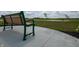 A green bench sits on a concrete patio overlooking community landscape at 5209 Cartland Dr, Indianapolis, IN 46239