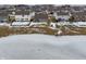 Aerial view of a neighborhood with houses near a frozen pond in winter at 5486 W Woodhaven Dr, McCordsville, IN 46055