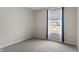 Bright bedroom with gray carpeting and a window with blue curtains at 5486 W Woodhaven Dr, McCordsville, IN 46055