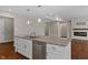 Kitchen island with granite countertop, sink, and dishwasher at 5486 W Woodhaven Dr, McCordsville, IN 46055