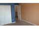 Bedroom with blue and tan walls and door to hallway at 5914 Mornay Dr, Indianapolis, IN 46254