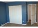 White double door closet in a blue bedroom at 5914 Mornay Dr, Indianapolis, IN 46254