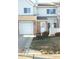 Attractive townhome with an attached garage, brick accents, and a welcoming front entrance at 5914 Mornay Dr, Indianapolis, IN 46254