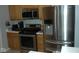 Stainless steel appliances in a kitchen with oak cabinets at 5914 Mornay Dr, Indianapolis, IN 46254