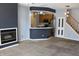 Open-concept living area offers a glimpse into the kitchen, complete with bar and staircase at 5914 Mornay Dr, Indianapolis, IN 46254
