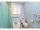 Bright bathroom featuring a toilet, colorful striped towels, and a window at 6234 Bobwhite Dr, Nineveh, IN 46164