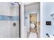 Tiled shower leads to a well-lit bathroom with sink, adding modern touch to functionality at 6234 Bobwhite Dr, Nineveh, IN 46164