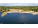 Picturesque aerial view of a sandy beach and a clubhouse nestled by a serene, expansive lake at 6234 Bobwhite Dr, Nineveh, IN 46164