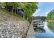 Waterfront home with private dock offering boat storage and access, complemented by a stone retaining wall at 6234 Bobwhite Dr, Nineveh, IN 46164