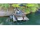 Waterfront property featuring a well-equipped boat dock with covered seating area and convenient boat lift for easy access at 6234 Bobwhite Dr, Nineveh, IN 46164