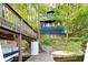 Exterior view of lakeside cottage showing multiple decks, boat dock and water access at 6234 Bobwhite Dr, Nineveh, IN 46164