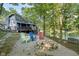 Inviting lake home featuring a cozy fire pit and colorful Adirondack chairs for outdoor relaxation and scenic views at 6234 Bobwhite Dr, Nineveh, IN 46164