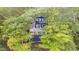 A charming blue two-story home nestled amongst lush, mature trees offering shade and privacy at 6234 Bobwhite Dr, Nineveh, IN 46164
