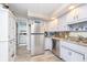 Well-lit kitchen with stainless-steel appliances, white cabinets, and modern finishes at 6234 Bobwhite Dr, Nineveh, IN 46164