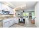 Bright kitchen features granite countertops, stainless steel appliances, and a breakfast bar leading to the deck at 6234 Bobwhite Dr, Nineveh, IN 46164