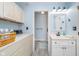Laundry and vanity with sink are adjacent to an enclosed shower creating a functional and accessible area at 6234 Bobwhite Dr, Nineveh, IN 46164
