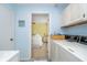 Laundry room leads to bedroom, has built-in cabinets providing storage for cleaning and laundry supplies at 6234 Bobwhite Dr, Nineveh, IN 46164