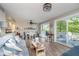 Bright living room featuring wood floors, a ceiling fan, a sliding glass door to deck, and lake-themed decor at 6234 Bobwhite Dr, Nineveh, IN 46164