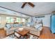 Spacious living room featuring a large sofa, wood floors, and view to the open dining area at 6234 Bobwhite Dr, Nineveh, IN 46164