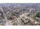 Stunning aerial view capturing homes in a neighborhood with mature trees, swimming pools, and winding roads at 6551 Forrest Commons Blvd, Indianapolis, IN 46277
