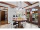 Dining Area with round wood table, decorative hanging lights, and view of the outside at 6551 Forrest Commons Blvd, Indianapolis, IN 46277