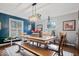 Dining room with modern lighting, blue accent wall, and light wood dining set at 6551 Forrest Commons Blvd, Indianapolis, IN 46277