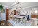 Elegant dining room with modern light fixture and views into the staircase and kitchen at 6551 Forrest Commons Blvd, Indianapolis, IN 46277
