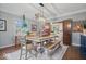Dining area with a large table, bench seating, and views into other rooms at 6551 Forrest Commons Blvd, Indianapolis, IN 46277