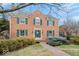 Charming two-story brick home with green shutters, a landscaped yard, and a welcoming front entrance at 6551 Forrest Commons Blvd, Indianapolis, IN 46277