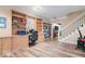Inviting home office boasts custom built-ins, desk space, and hardwood floors leading to the staircase at 6551 Forrest Commons Blvd, Indianapolis, IN 46277