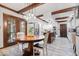 Open-concept kitchen with an island, stainless steel appliances, and wood beams at 6551 Forrest Commons Blvd, Indianapolis, IN 46277