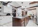 Bright kitchen with dark wood island, white cabinets, stainless steel appliances, and beamed ceilings at 6551 Forrest Commons Blvd, Indianapolis, IN 46277