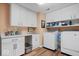 Functional laundry room with ample counter space, storage cabinets, washer, and dryer for convenience at 6551 Forrest Commons Blvd, Indianapolis, IN 46277