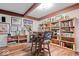 Multipurpose living area featuring built-in bookshelves, a table with chairs, and decorative wall art at 6551 Forrest Commons Blvd, Indianapolis, IN 46277