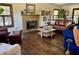 Inviting living room features a cozy fireplace, rich wood floors, and comfortable seating at 6551 Forrest Commons Blvd, Indianapolis, IN 46277