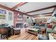 Comfortable living room with a fireplace, wood flooring, bookshelves, and plentiful seating arrangements at 6551 Forrest Commons Blvd, Indianapolis, IN 46277