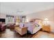 The main bedroom features a ceiling fan, two windows, and a sitting area at 6551 Forrest Commons Blvd, Indianapolis, IN 46277