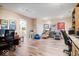 Large office with wood flooring, multiple desk spaces, and additional space for recreational activities at 6551 Forrest Commons Blvd, Indianapolis, IN 46277