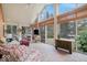 Bright sunroom with brick flooring, a ceiling fan, and several windows at 6551 Forrest Commons Blvd, Indianapolis, IN 46277