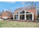 Bright sunroom with large windows, brick floors, and access to the backyard patio at 6551 Forrest Commons Blvd, Indianapolis, IN 46277